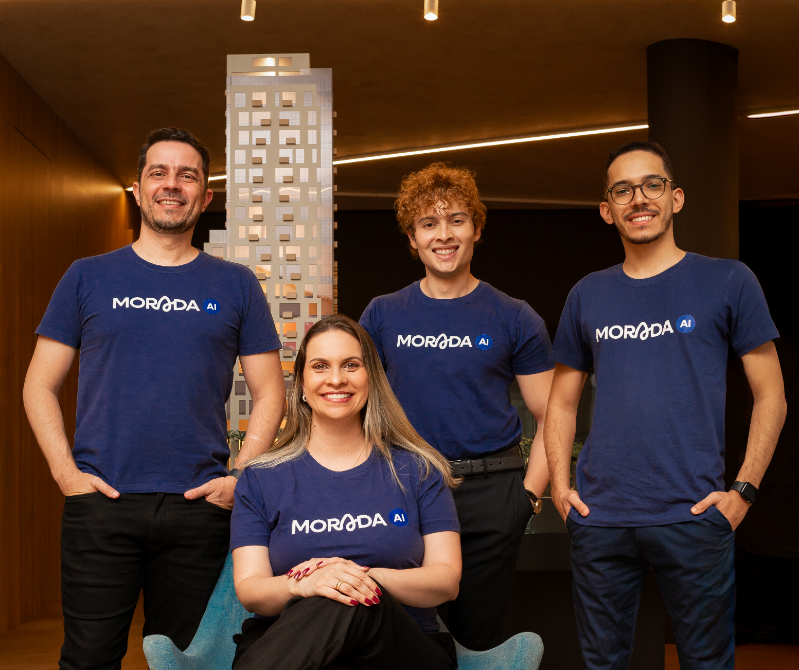 inteligência artificial condomínio - equipe de tecnologia imobiliária apresentando solução de IA com maquete arquitetônica ao fundo